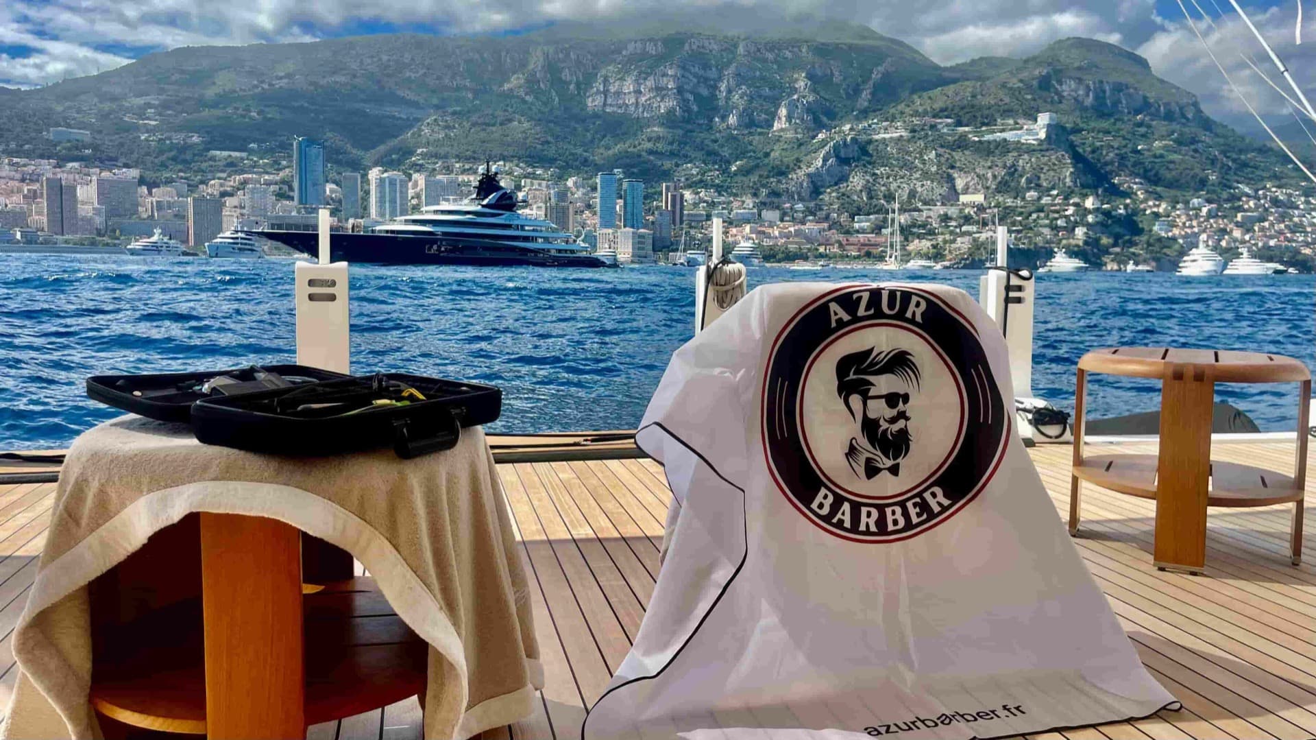 The Azur Barber kit set up on a yacht deck, facing Monaco